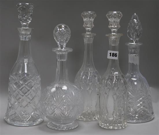 A pair of cut glass decanters and three others